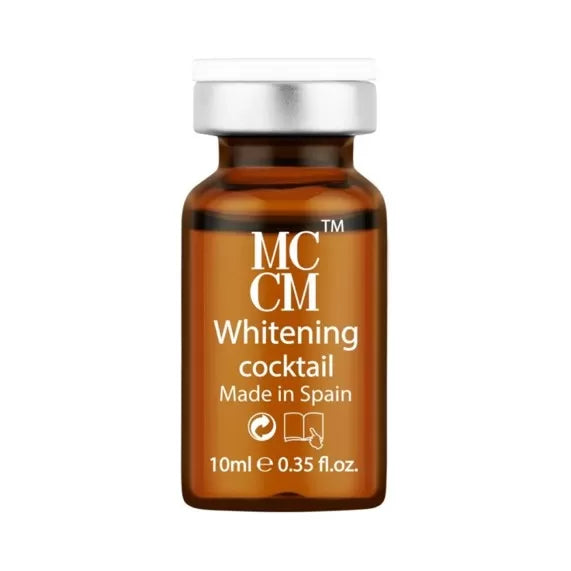 Close-up of a single MCCM Whitening cocktail ampule, labeled with information including 'Made in Spain' and dosage details.