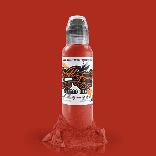 Application of WORLD FAMOUS Red Hot 15ml Tattoo Ink on skin, demonstrating its smooth flow and fast healing properties for artists.