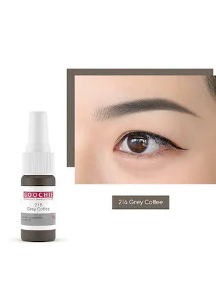 Close-up of Goochie Grey Coffee 216 eyebrow pigment bottle next to a model's eye showcasing the color's application.