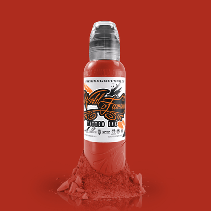 Application of WORLD FAMOUS Red Hot 15ml Tattoo Ink on skin, demonstrating its smooth flow and fast healing properties for artists.